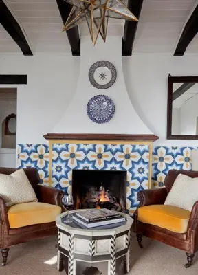 a living room with two chairs and a fireplace at Casa Laguna Hotel & Spa in Laguna Beach