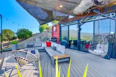 a living room with a couch and chairs on a deck at Fallbrook Airplane Home with Fire Pit and Mtn Views! in Temecula