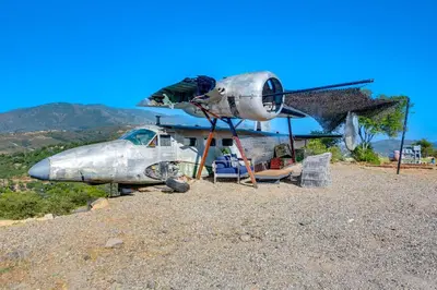 an old airplane sitting on top of a pile of gravel at Fallbrook Airplane Home with Fire Pit and Mtn Views! in Temecula