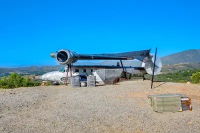 a small airplane sitting on top of a hill at Fallbrook Airplane Home with Fire Pit and Mtn Views! in Temecula