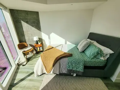 a bedroom with a bed with pillows on it at Bayviews Lux One-bedroom Apartment 1min to Petco Park Convention Center Gaslamp Pool, Hot Tub in San Diego
