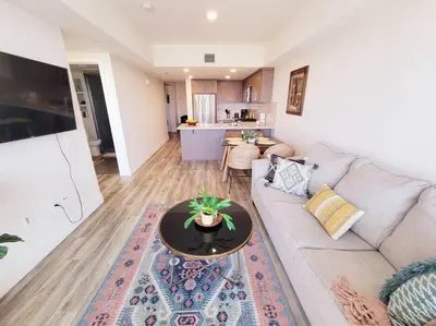 a living room with a couch and a table at Bayviews Lux One-bedroom Apartment 1min to Petco Park Convention Center Gaslamp Pool, Hot Tub in San Diego