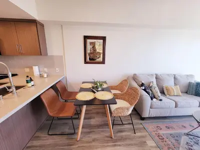 a kitchen and living room with a table and a couch at Bayviews Lux One-bedroom Apartment 1min to Petco Park Convention Center Gaslamp Pool, Hot Tub in San Diego