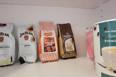 a shelf with four bags of coffee and a cup of coffee at Bayviews Lux One-bedroom Apartment 1min to Petco Park Convention Center Gaslamp Pool, Hot Tub in San Diego