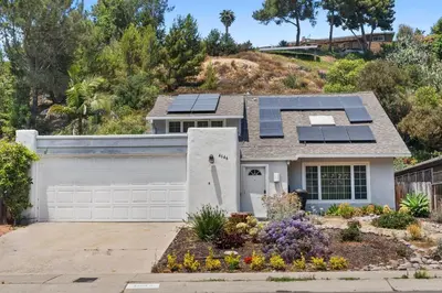 a house with solar panels on the roof at Restful Retreat - Vibrant - Tranquil Yard in San Diego