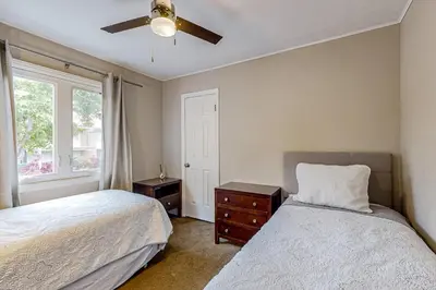 a bedroom with two beds and a ceiling fan at Playa Del Sur Getaway La Jolla in San Diego
