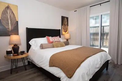 a bedroom with a large bed and a window at Modern Ocean Beach Apartment in San Diego