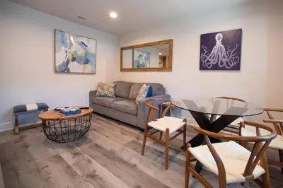 a living room with a couch and a table at Modern Ocean Beach Apartment in San Diego
