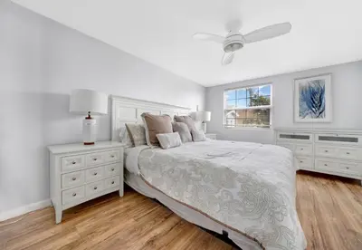 a white bedroom with a bed and a window at 1404 W Oceanfront B in Newport Beach