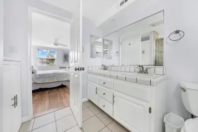 a white bathroom with a sink and a toilet at 1404 W Oceanfront B in Newport Beach