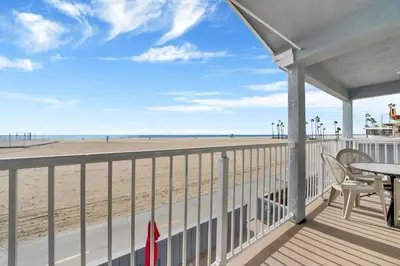 a balcony with a table and chairs and the beach at 1404 W Oceanfront B in Newport Beach