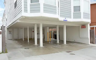 a large white building with pillars in a parking lot at 1404 W Oceanfront B in Newport Beach
