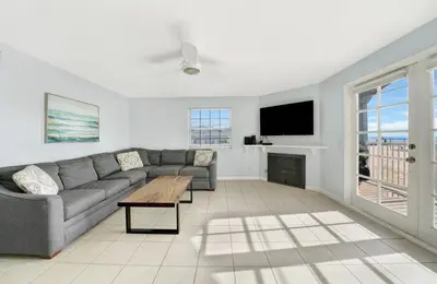 a living room with a couch and a tv at 1404 W Oceanfront B in Newport Beach