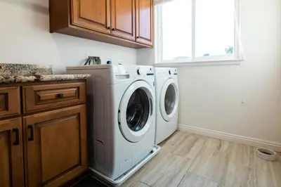 a laundry room with a washer and dryer at Amethyst Hearth - Family Spa Serenity, Zoo, Beach, Disneyland, Legoland in Vista