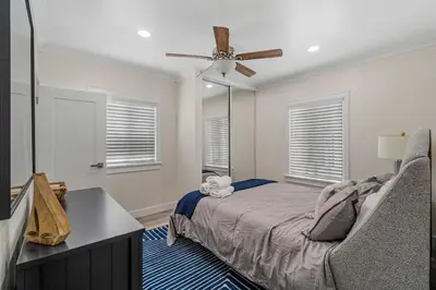a bedroom with a bed and a ceiling fan at Carlsbad Blvd Villa in Carlsbad