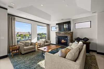 a living room with a couch and a fireplace at Dana Point Luxe in Dana Point