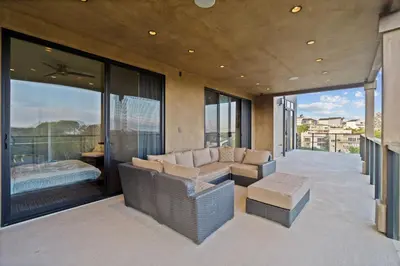 a living room with a couch and some windows at Dana Point Luxe in Dana Point