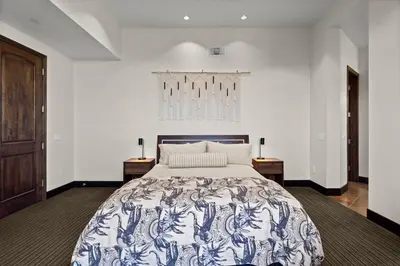 a bedroom with a bed with a blue and white bedspread at Dana Point Luxe in Dana Point