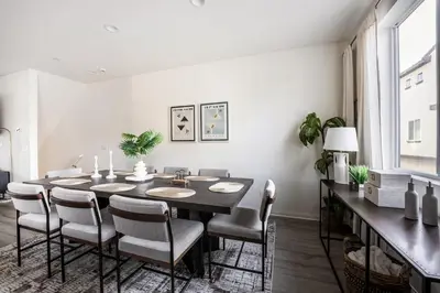 a dining room with a table and chairs at Brand New Stunning 4BR Townhome in Lemon Grove