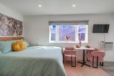 a bedroom with a bed and a table and a window at Studio Verde- Free Parking, Central in San Diego