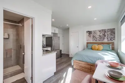 a small bedroom with a bed and a bathroom at Studio Verde- Free Parking, Central in San Diego
