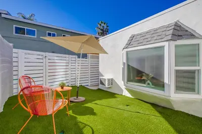 a patio with a table and a chair and an umbrella at Studio Verde- Free Parking, Central in San Diego