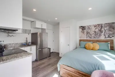 a bedroom with a bed and a kitchen at Studio Verde- Free Parking, Central in San Diego