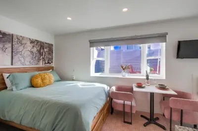 a bedroom with a bed and a table and a window at Studio Verde- Free Parking, Central in San Diego