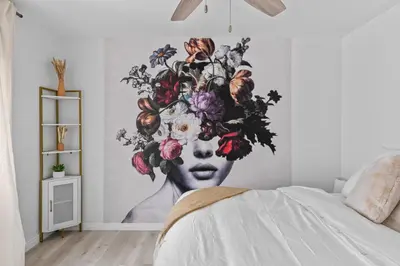 a mural of a woman with flowers on a wall at Urban Spanish Bungalow in San Diego