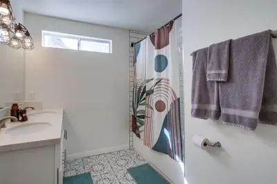 a bathroom with a shower and a sink at Urban Spanish Bungalow in San Diego