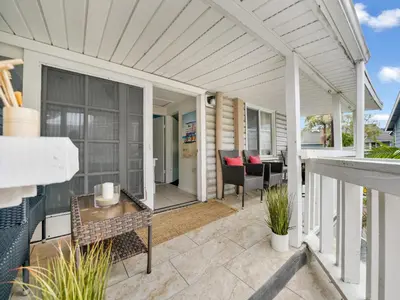 a patio with a table and chairs on a house at 122 Thirty Third Street in Newport Beach