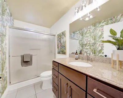 a bathroom with a toilet and a sink and a shower at 122 Thirty Third Street in Newport Beach