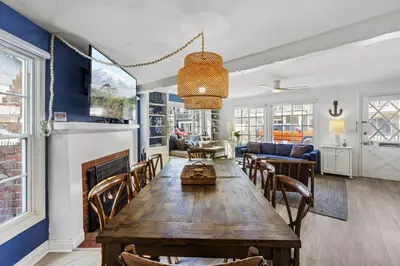 a living room with a table and a fireplace at 122 Thirty Third Street in Newport Beach