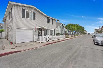 a house on a street with a car parked on the street at 122 Thirty Third Street in Newport Beach