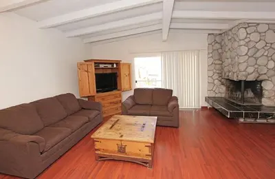 a living room with a couch and a fireplace at 124 Thirty Fourth Street B in Newport Beach