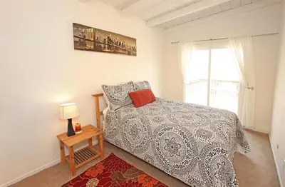 a bedroom with a bed and a window at 124 Thirty Fourth Street B in Newport Beach