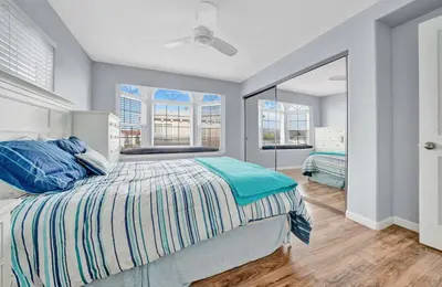a bedroom with a bed and a mirror at 1404 W Oceanfront C in Newport Beach