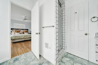 a bathroom with a white door and a bedroom at 1404 W Oceanfront C in Newport Beach