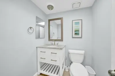 a white bathroom with a toilet and a sink at 1404 W Oceanfront C in Newport Beach