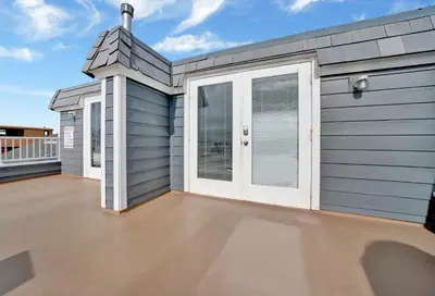 a house with white doors on a roof at 1404 W Oceanfront C in Newport Beach