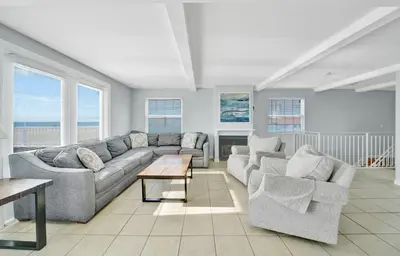 a living room with a couch and two chairs and a table at 1404 W Oceanfront C in Newport Beach