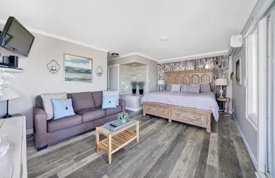 a bedroom with a bed and a couch at 2314 W Oceanfront A & B in Newport Beach