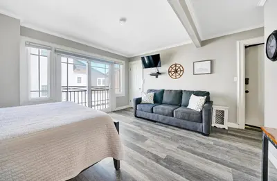a bedroom with a bed and a couch at 2314 W Oceanfront A & B in Newport Beach