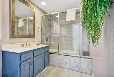 a bathroom with a blue sink and a shower at 2314 W Oceanfront A & B in Newport Beach