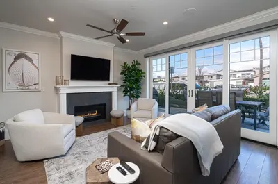 a living room with a couch and a fireplace at 1225 W Balboa Blvd A & B in Newport Beach