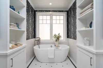 a white bathroom with a tub and a window at 1225 W Balboa Blvd A & B in Newport Beach