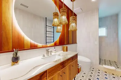a bathroom with a sink and a mirror at Neptune Sunset Shores Oceanfront in Encinitas