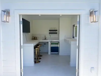 a kitchen with white counters and a large open door at Elegant 2BR with Outdoor Space in Carlsbad
