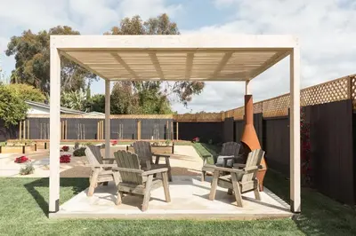 a wooden gazebo with chairs and a table at Elegant 2BR with Outdoor Space in Carlsbad