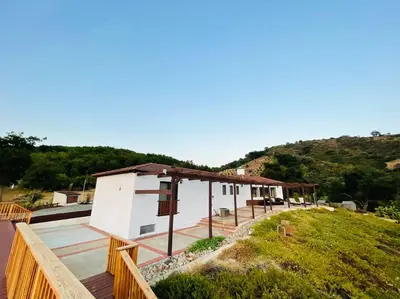 a house with a wooden fence next to a building at Panorama Paradiso by CasadeLuz, 5Acre 360 Retreat close to Old Town Temecula Wine Country in Temecula